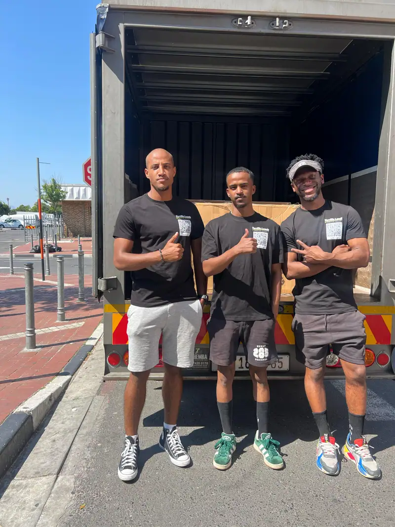 Three Terrific Loads team members standing in front of their delivery truck