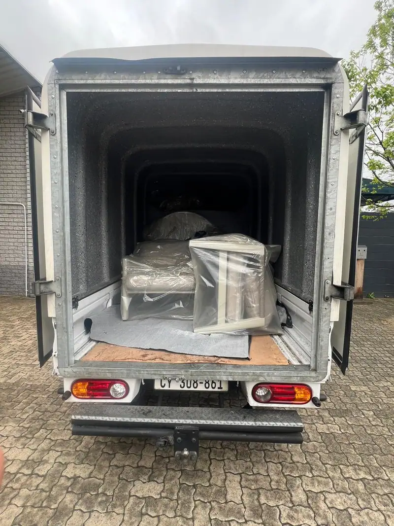 Delivery truck loaded with wrapped furniture